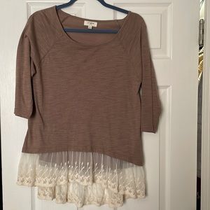 Brown quarter inch sleeve blouse with lace trim at the bottom